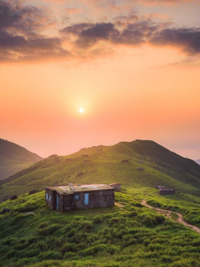 small-house-built-peaceful-green-hill-high-up-mountains-min